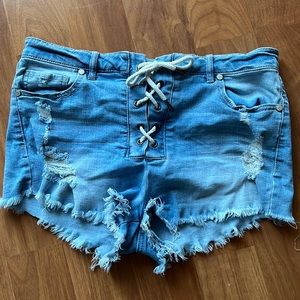Refuge cut off shorts. Light blue denim with criss cross stitch up detail.